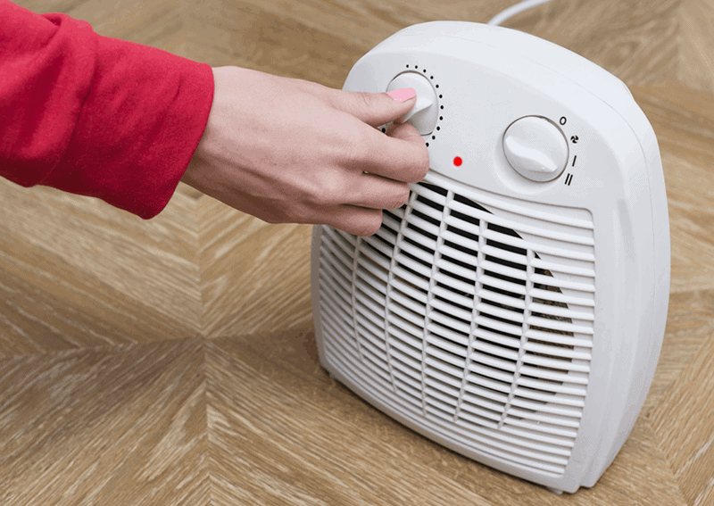 Adjusting a space heater to save money on your heating bill