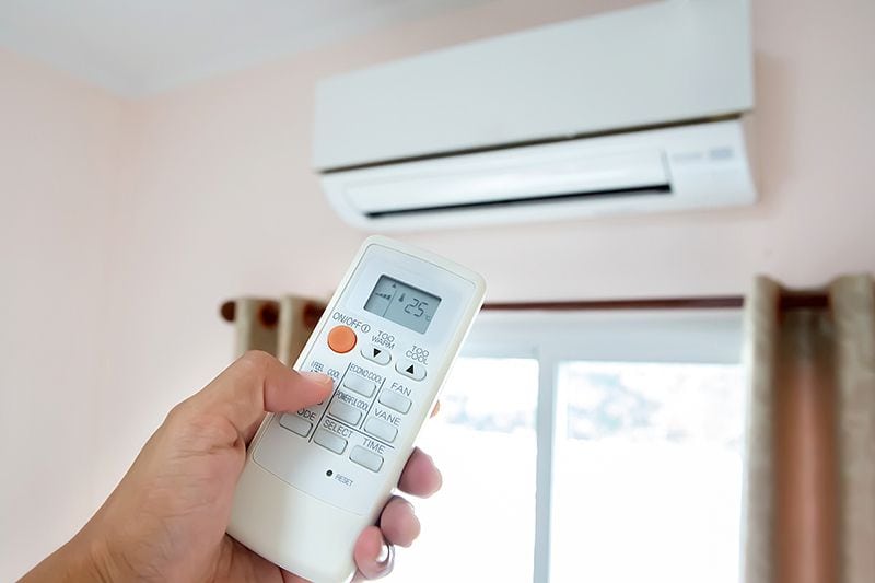 Why Is My Heat Pump Blowing Cold Air? - Man Using Heat Pump.